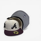 New Era fitted cap with black and white A logo, cream crown, and purple brim, sneakers, hats