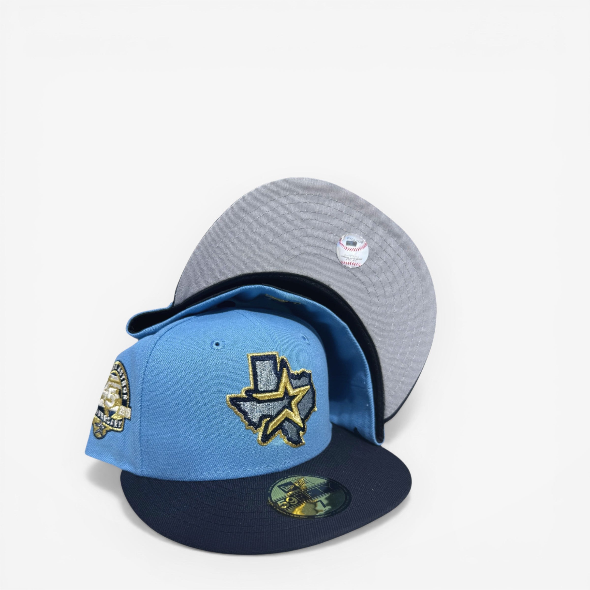 METRO Houston Astros 45th Anniversary blue fitted hat with navy brim and grey UV underbrim, featuring a commemorative side patch.