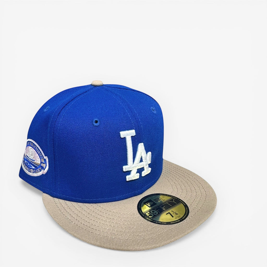 METRO LA Dodgers 50th Anniversary fitted hat in blue with white LA logo, beige brim, and pink UV underbrim.