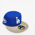 METRO LA Dodgers 50th Anniversary fitted hat in blue with white LA logo, beige brim, and pink UV underbrim.