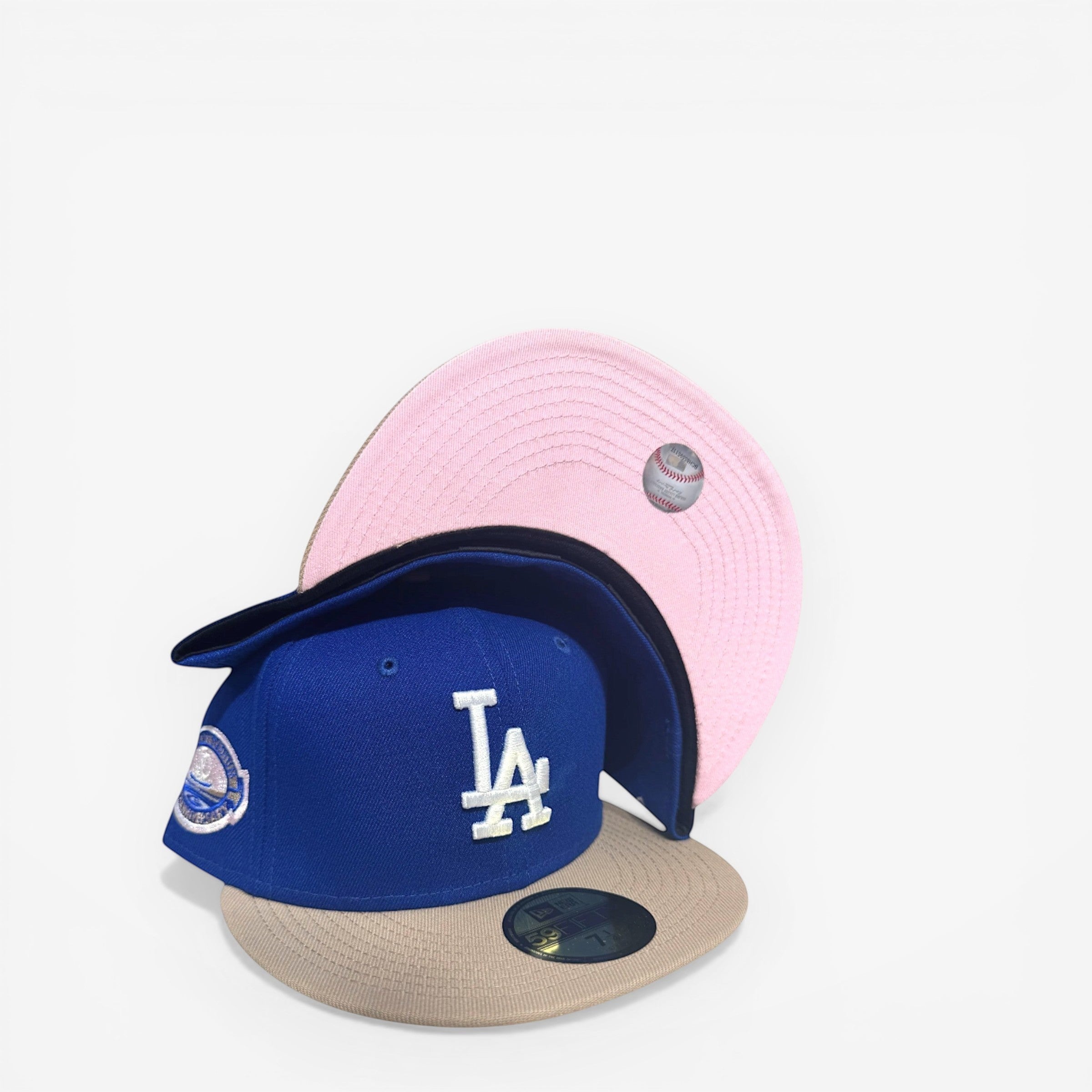 METRO LA Dodgers 50th Anniversary fitted hat in blue with white LA logo, beige brim, and pink UV underbrim.
