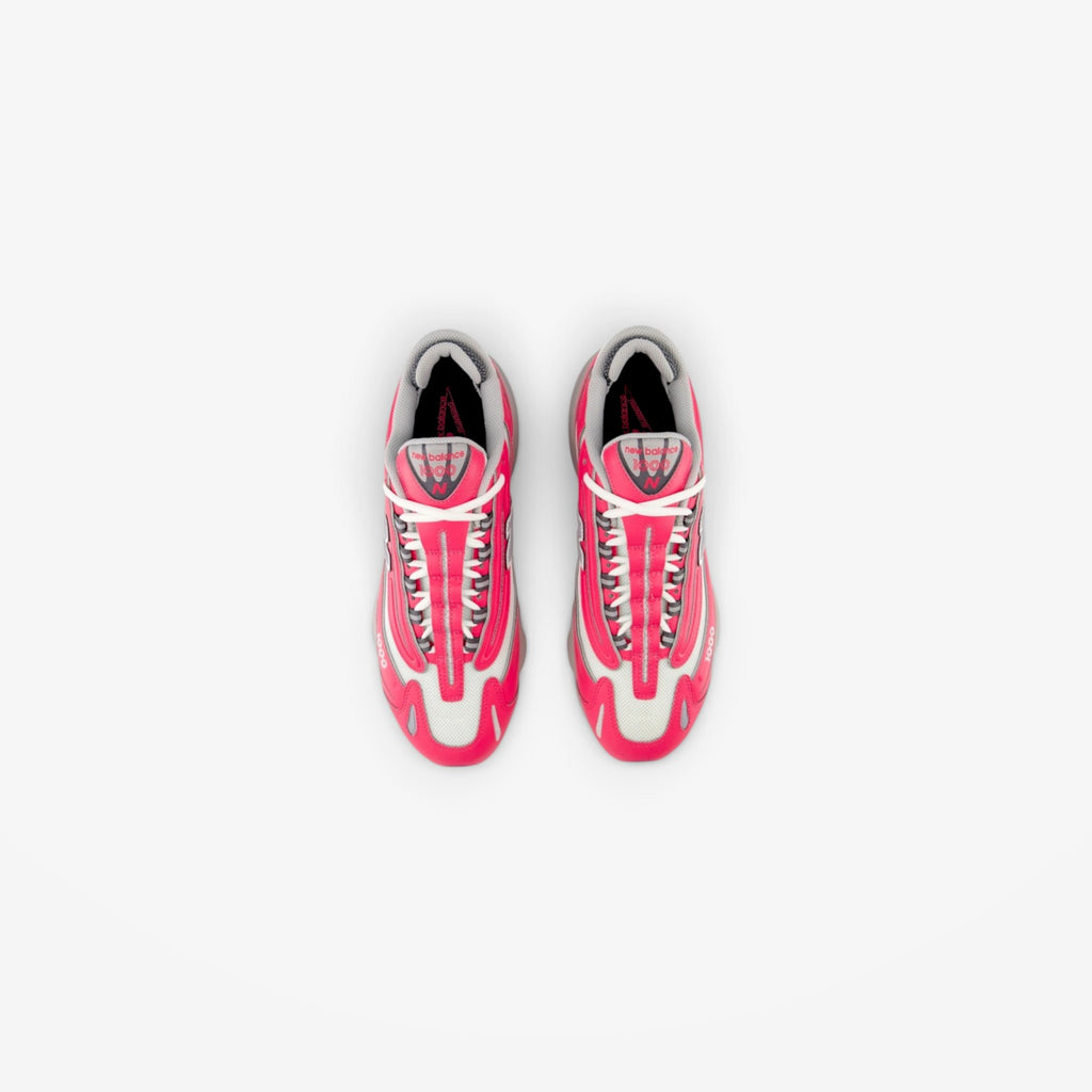 METRO New Balance 1000 sneakers in Dragon Berry pink and metallic silver, top-down view of athletic running shoes.