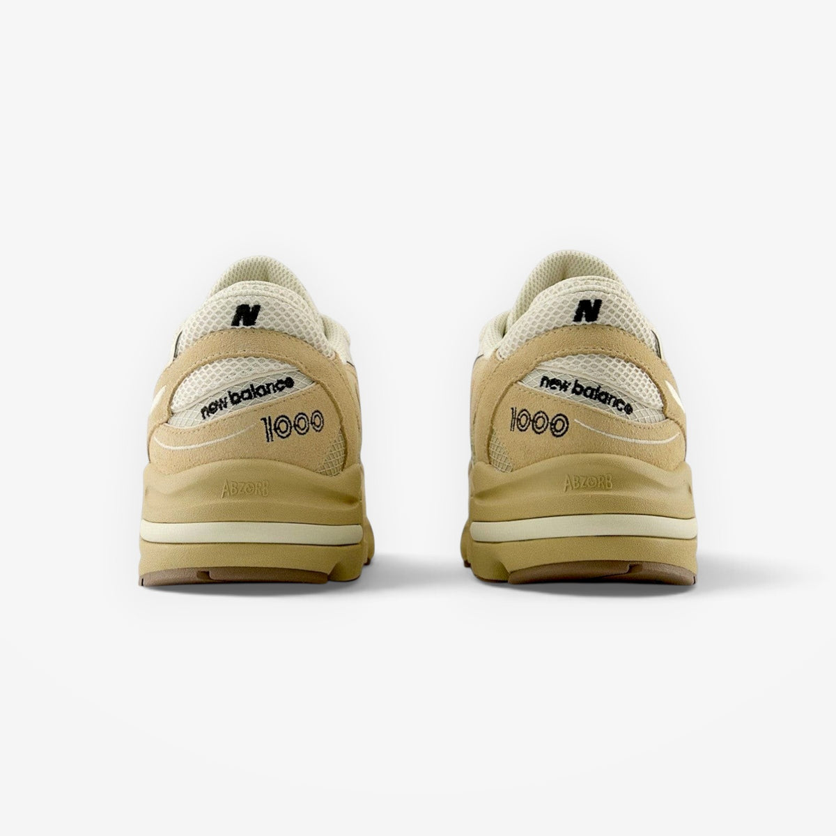 Rear view of METRO New Balance 1000 sneakers in incense and black with suede overlays and ABZORB cushioning.