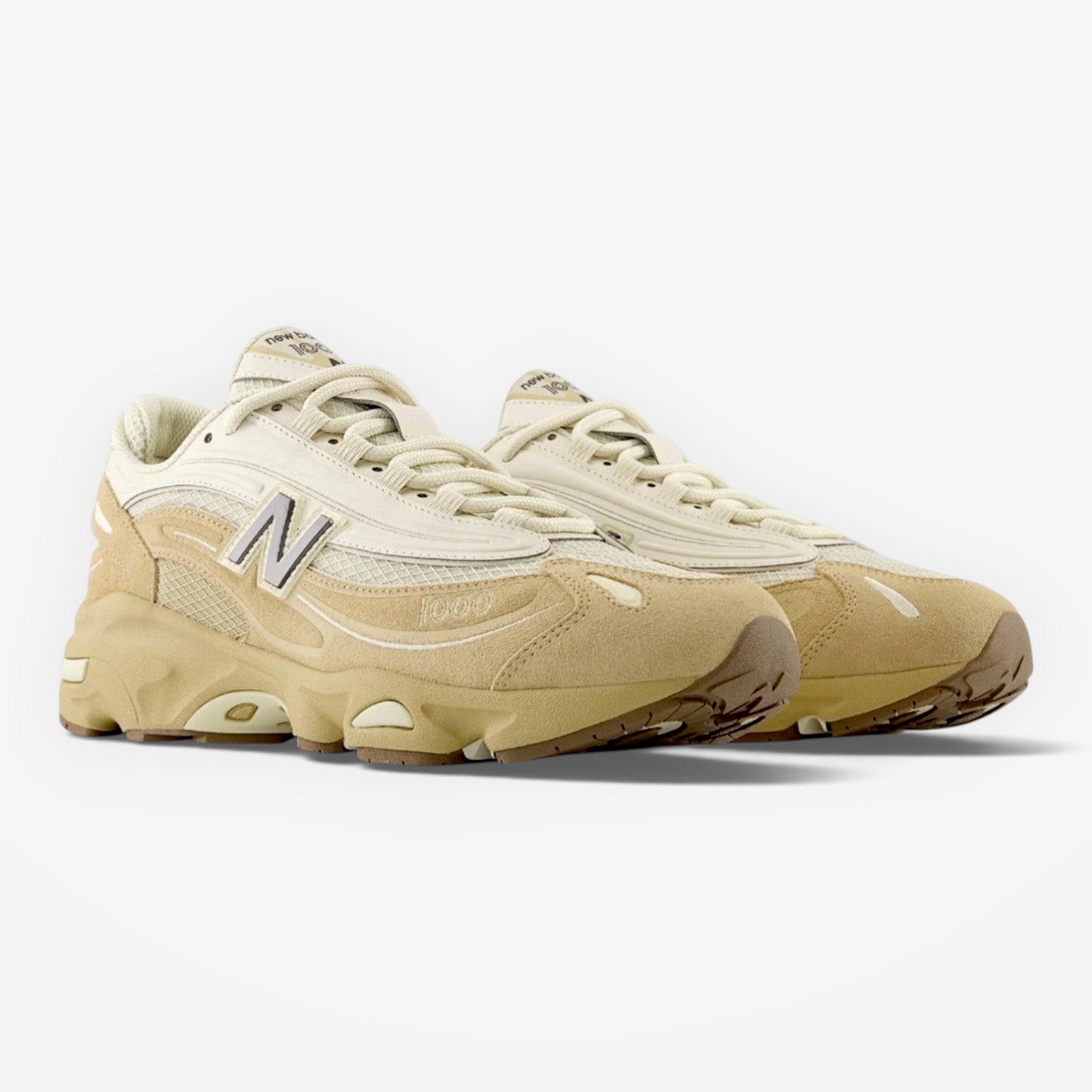 METRO New Balance 1000 sneakers in incense and black with suede overlays, mesh underlays, and ABZORB cushioning.