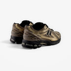 METRO New Balance 1906R sneakers in black and bronze featuring a mesh and suede upper with cushioned midsole