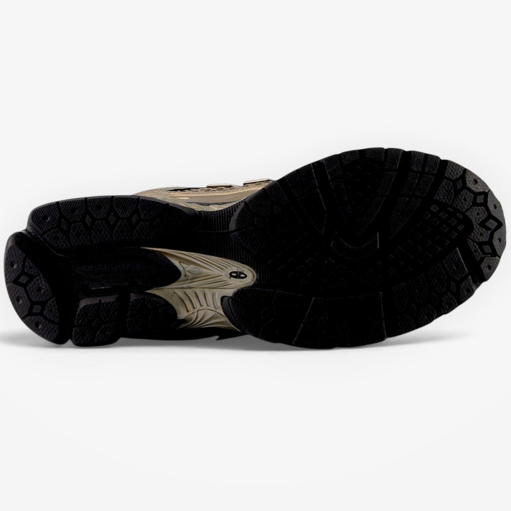 METRO New Balance 1906R sneaker showing the black and bronze textured rubber outsole and cushioned midsole design