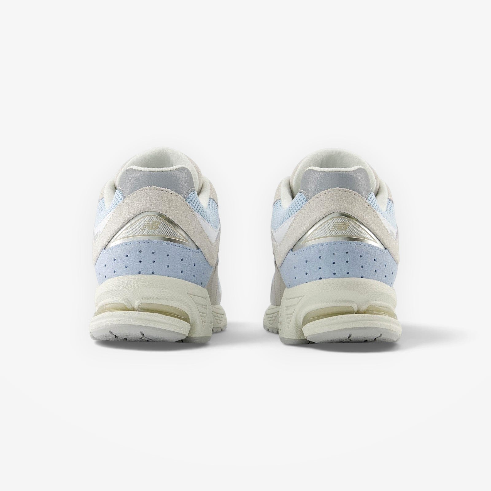 METRO New Balance 2002R sneakers in blue suede and mesh, showing the rear heel view with N-ergy foam midsole cushioning.