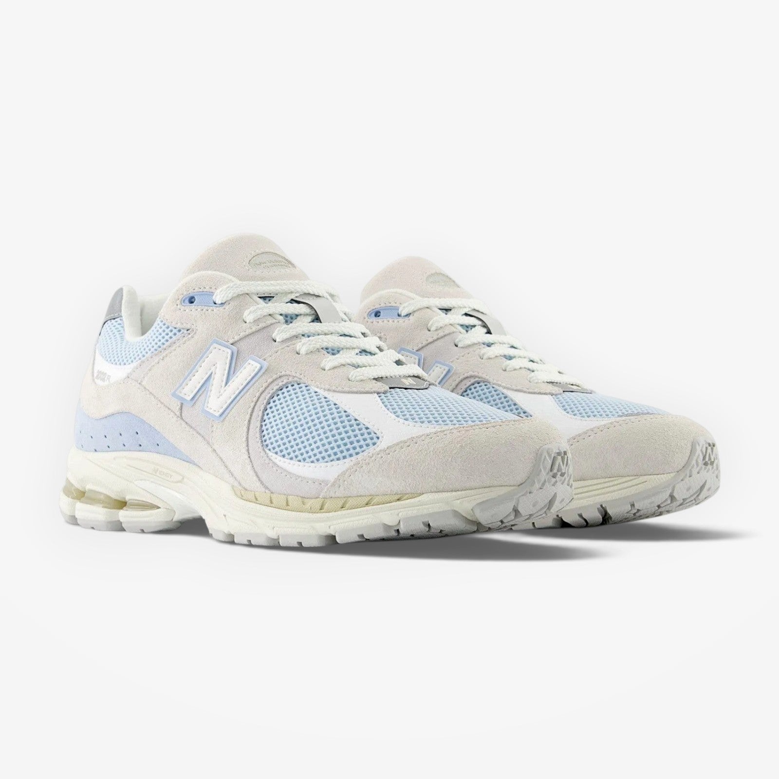 METRO New Balance 2002R sneakers in blue and off-white featuring a suede and mesh upper with N-ergy foam midsole.