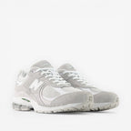 New Balance grey and white suede mesh sneakers, lifestyle footwear, front angle view