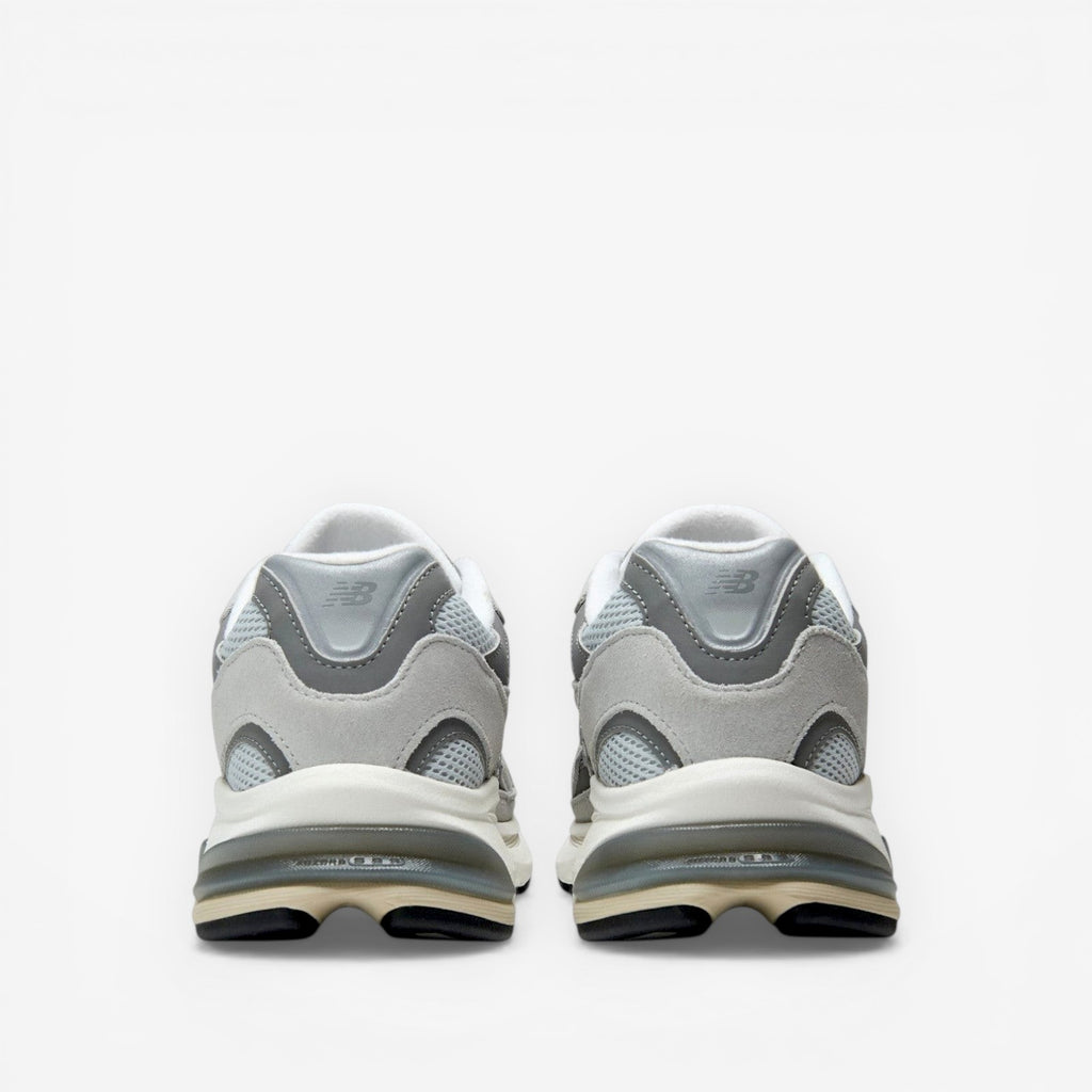 METRO New Balance 2010 sneakers in Raincloud and Harbor Grey. Mesh, suede, and synthetic upper with cushioned foam midsole and rubber outsole.
