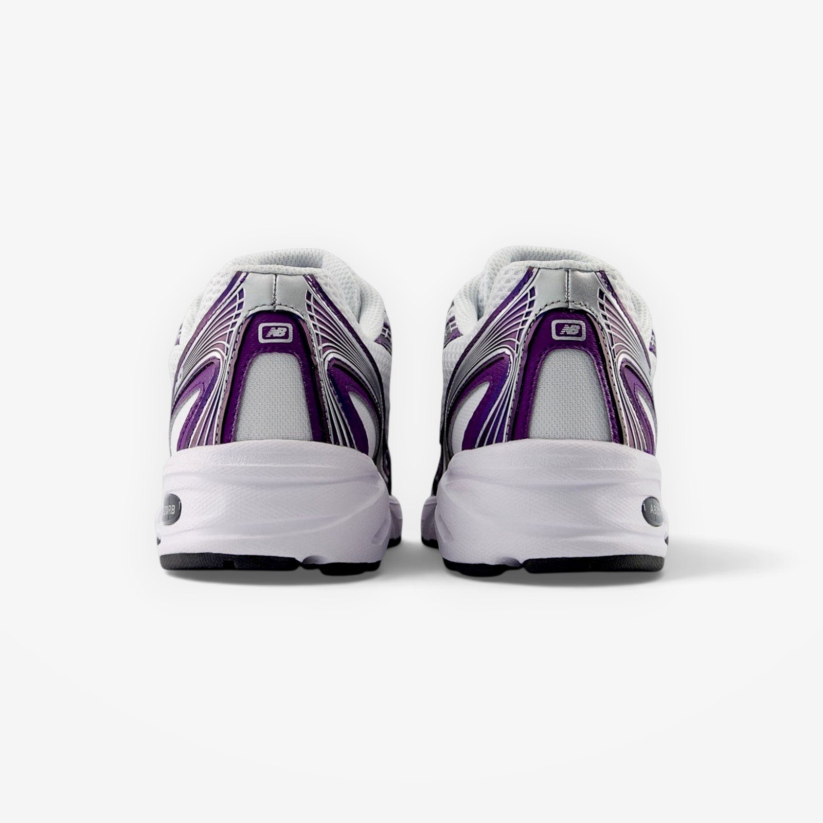 Rear view of METRO New Balance 740 sneakers in Concord Grape featuring mesh, suede, and synthetic purple accents.