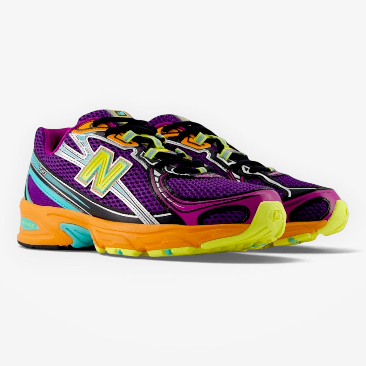 METRO New Balance 740 running shoe in purple, orange, and yellow with open knit mesh and angular overlays.