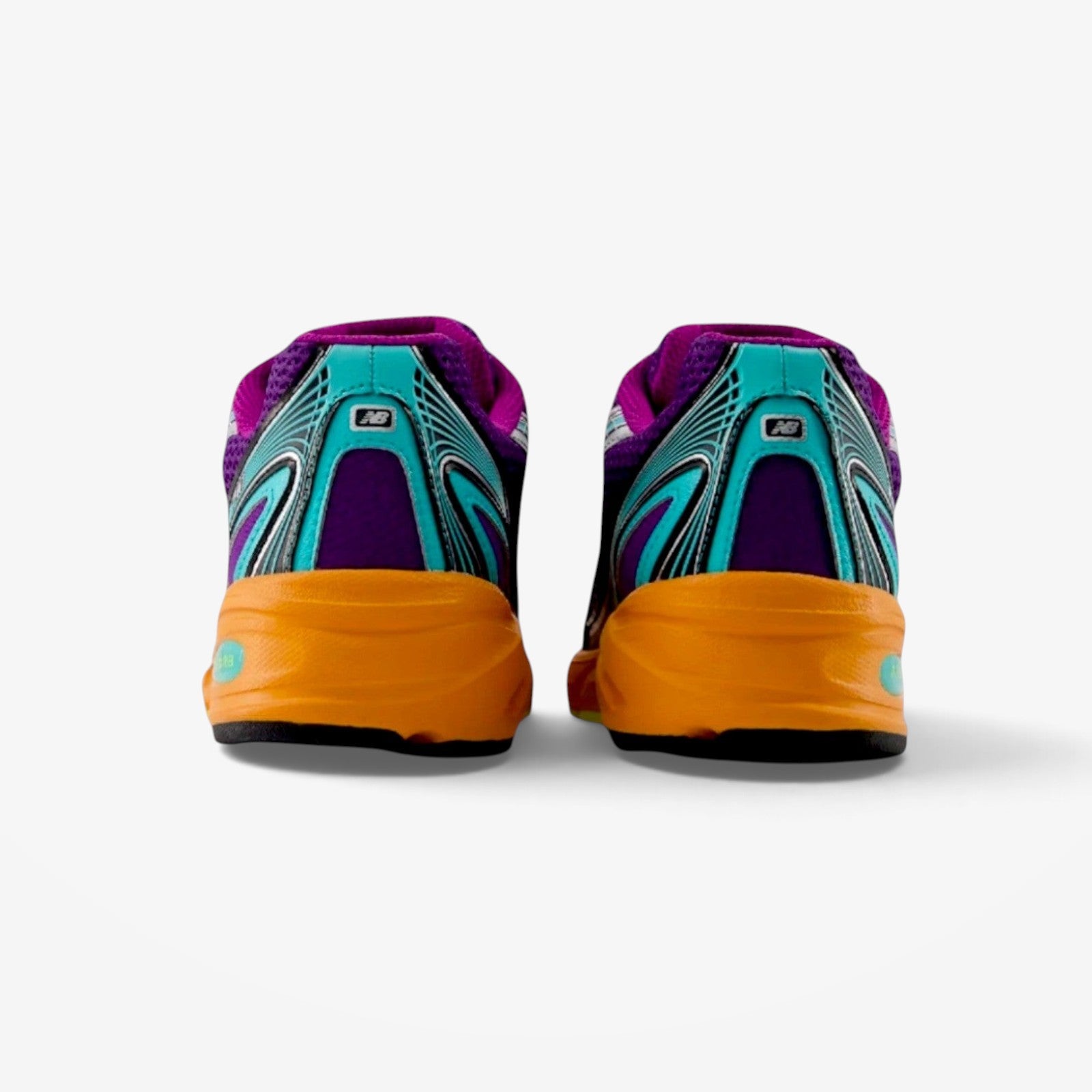 METRO New Balance 740 sneakers in purple, teal, and orange with open knit mesh and angular heel overlays