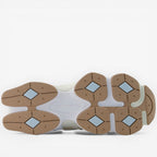 New Balance sneaker outsole with tan, white, and blue details, stylish footwear design