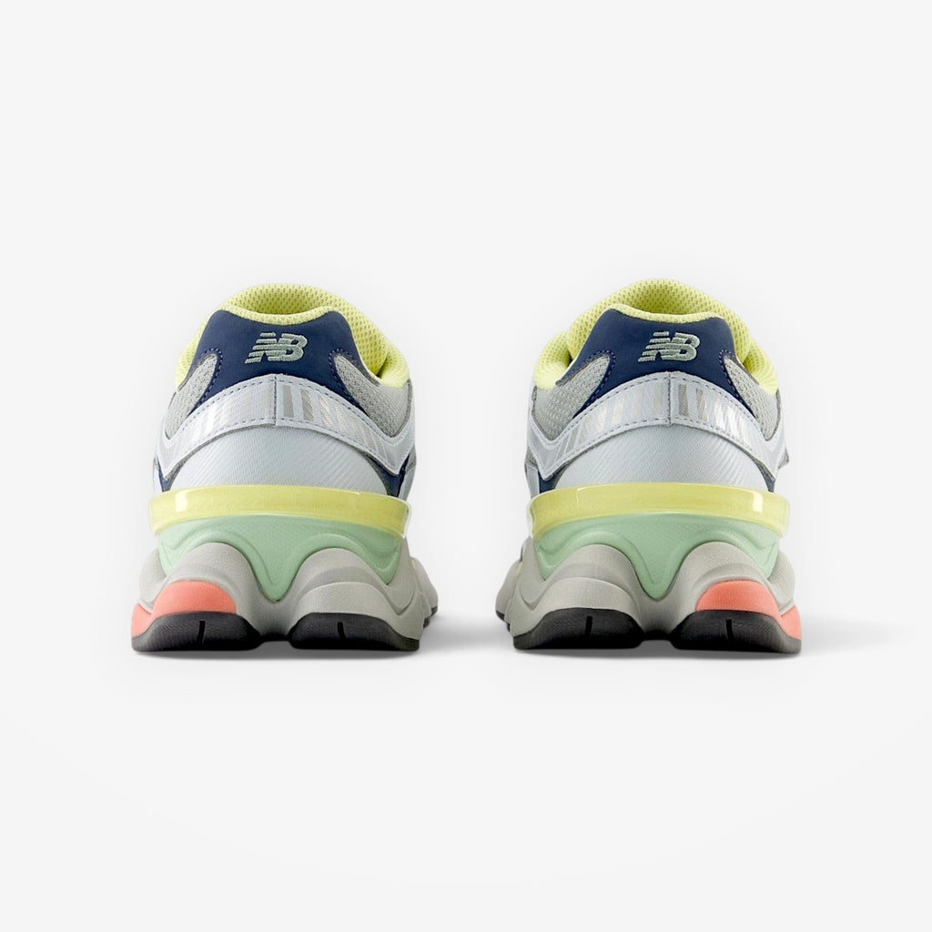 METRO New Balance 9060 Ice Blue sneakers, rear view showing sculpted midsole, mesh upper, and vibrant accent details.