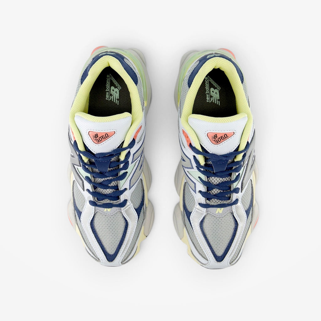 METRO New Balance 9060 Ice Blue sneakers featuring a layered mesh and suede upper with yellow and coral accents.