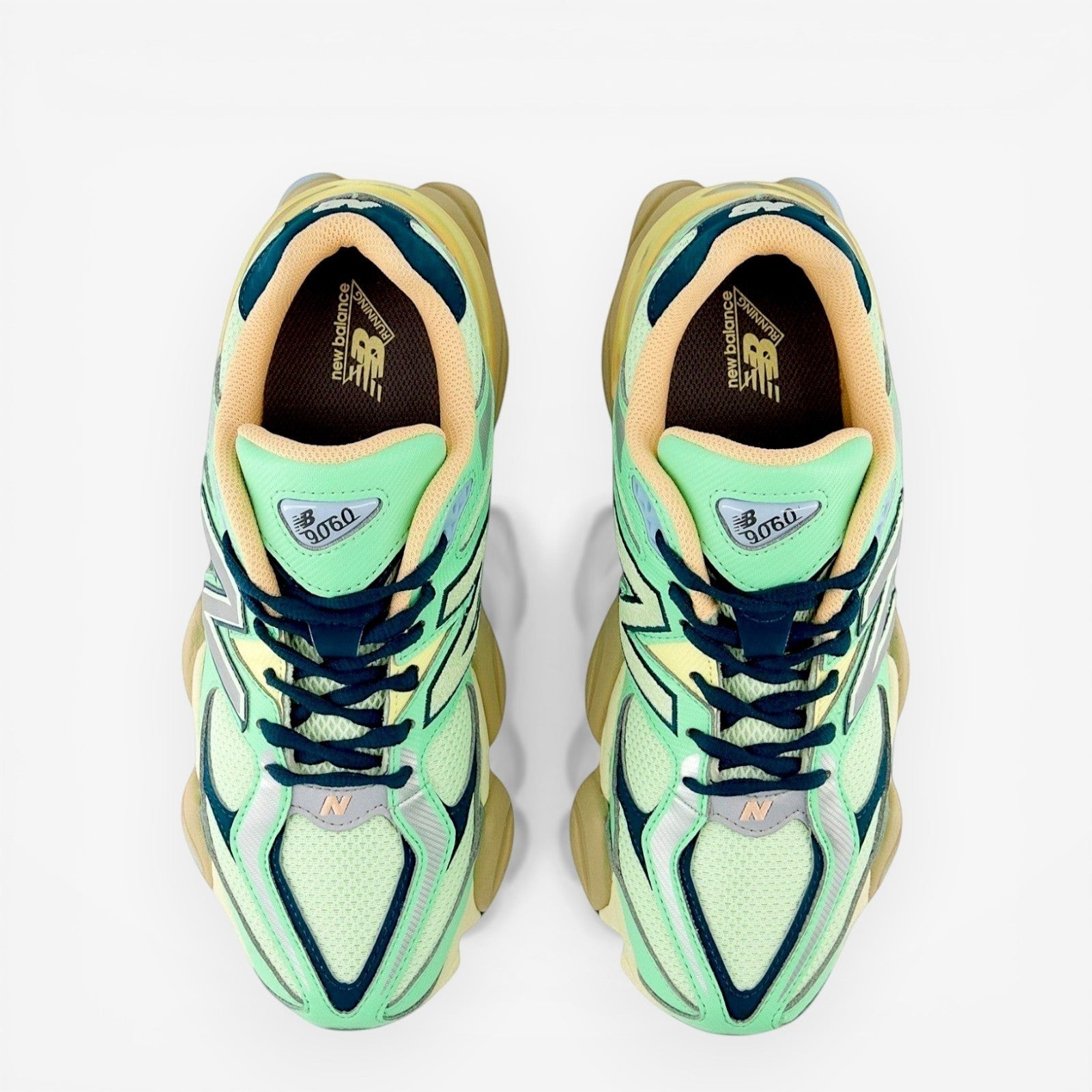 Top view of New Balance sneakers with mint green mesh, beige lining, and chunky sole