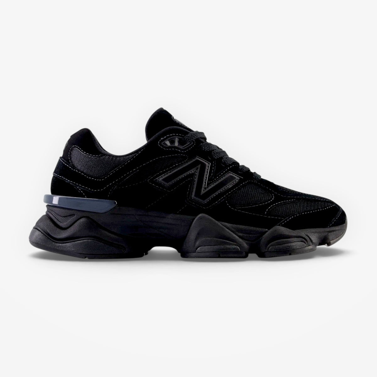 METRO New Balance 9060 Triple Black sneaker with suede and mesh upper, featuring a sculpted midsole and lace-up design.