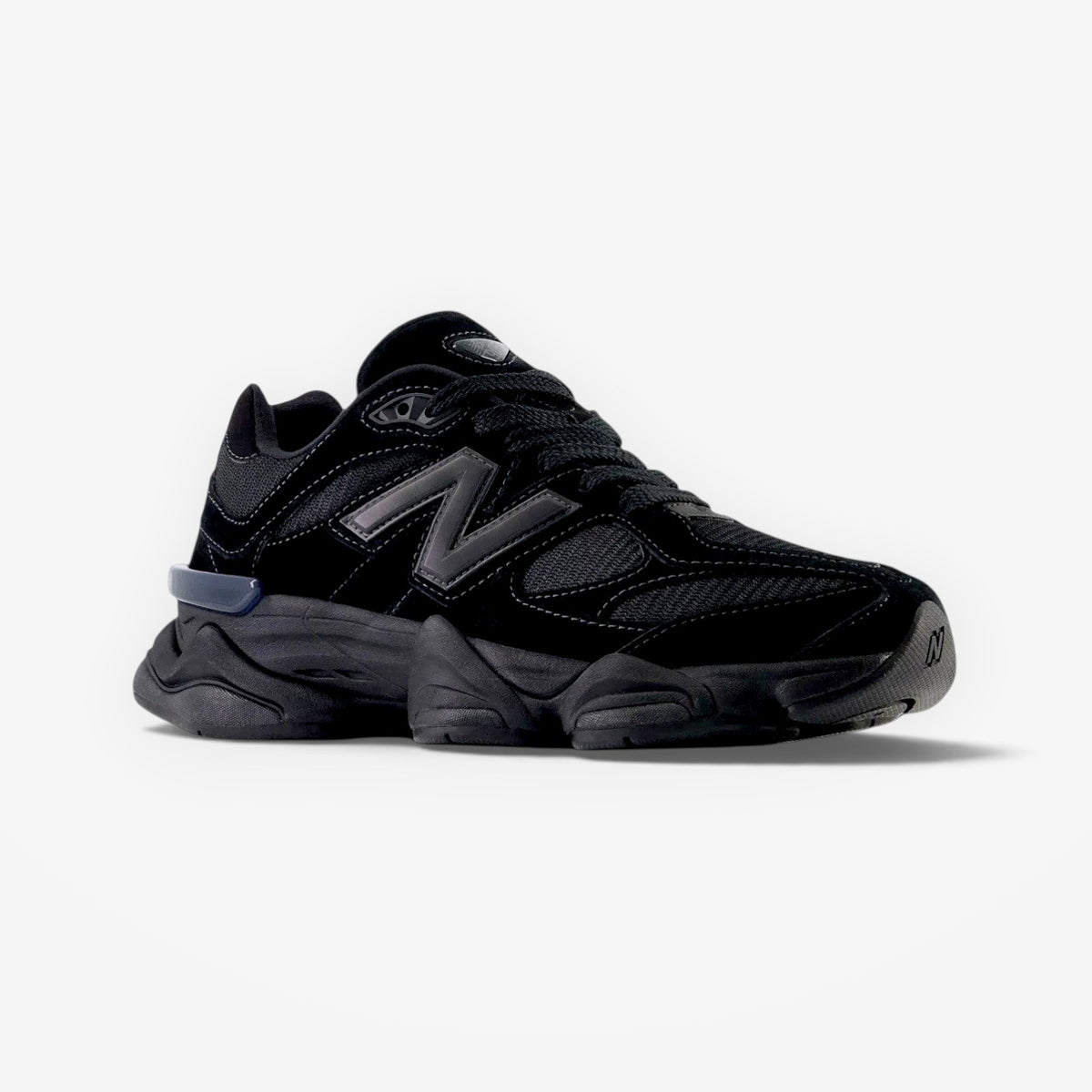 METRO New Balance 9060 Triple Black sneaker featuring a layered suede and mesh upper with a sculpted rubber midsole.