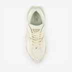 METRO New Balance 9060 sneakers in white and gray, featuring mesh and suede, ABZORB cushioning, and a rubber sole.