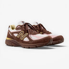 METRO New Balance 990v4 Made in USA sneaker in pumpernickel brown suede with pink chalk and alabaster mesh accents.