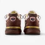 METRO New Balance 990v4 Made in USA sneakers in pumpernickel brown suede with pink and alabaster accents, rear view.