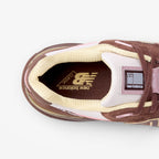 METRO New Balance 990v4 Made in USA sneaker top view showing pumpernickel suede, pink chalk accents, and alabaster mesh.
