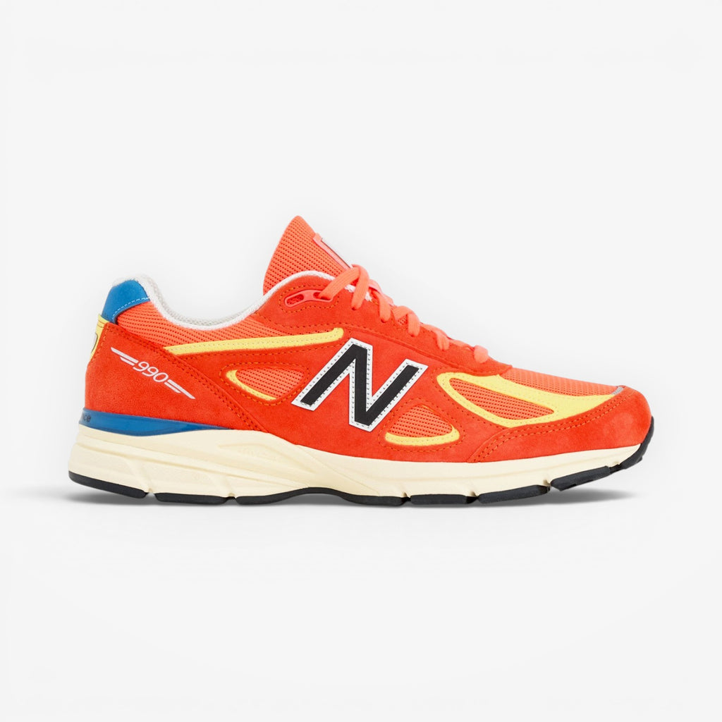 METRO New Balance 990v4 Made in USA Urgent Red suede and mesh running shoe with yellow accents and cream sole.