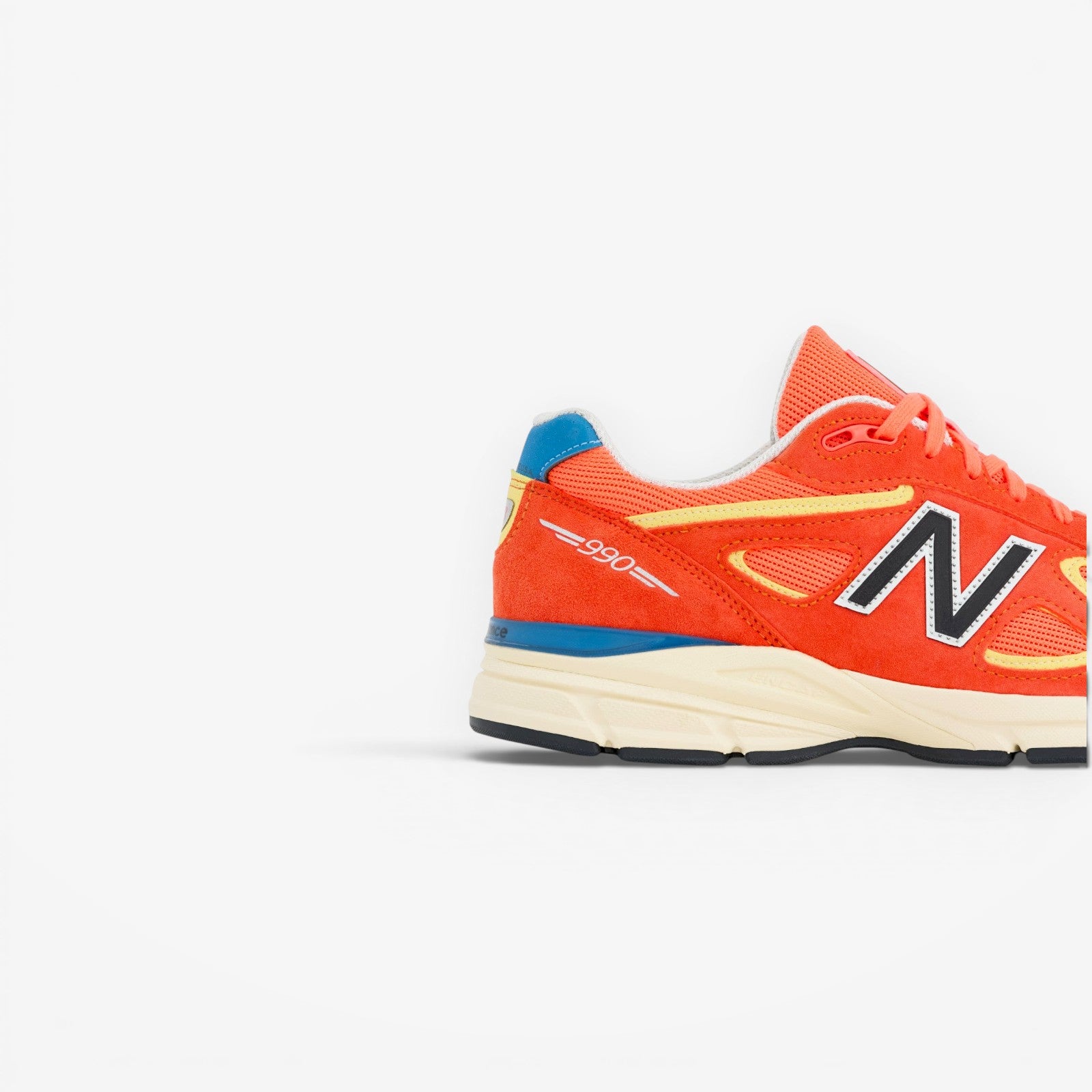 METRO New Balance 990v4 Made in USA Urgent Red suede and mesh running shoe with yellow and blue accents.