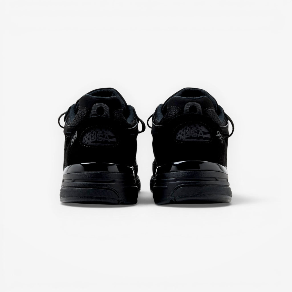 METRO New Balance 993 Made in USA sneakers in triple black suede and mesh, rear view showing heel branding.