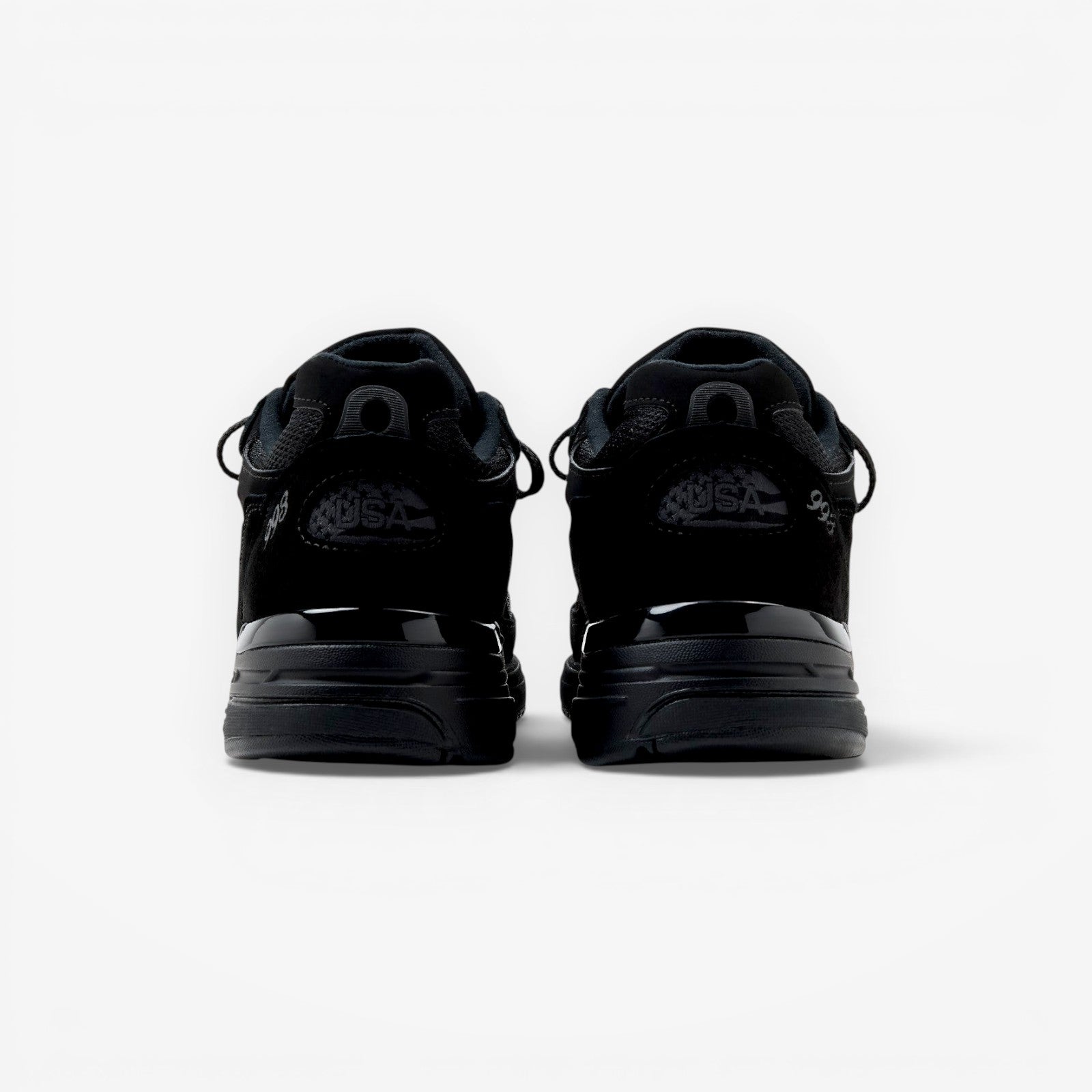 METRO New Balance 993 Made in USA sneakers in triple black suede and mesh, rear view showing heel branding.