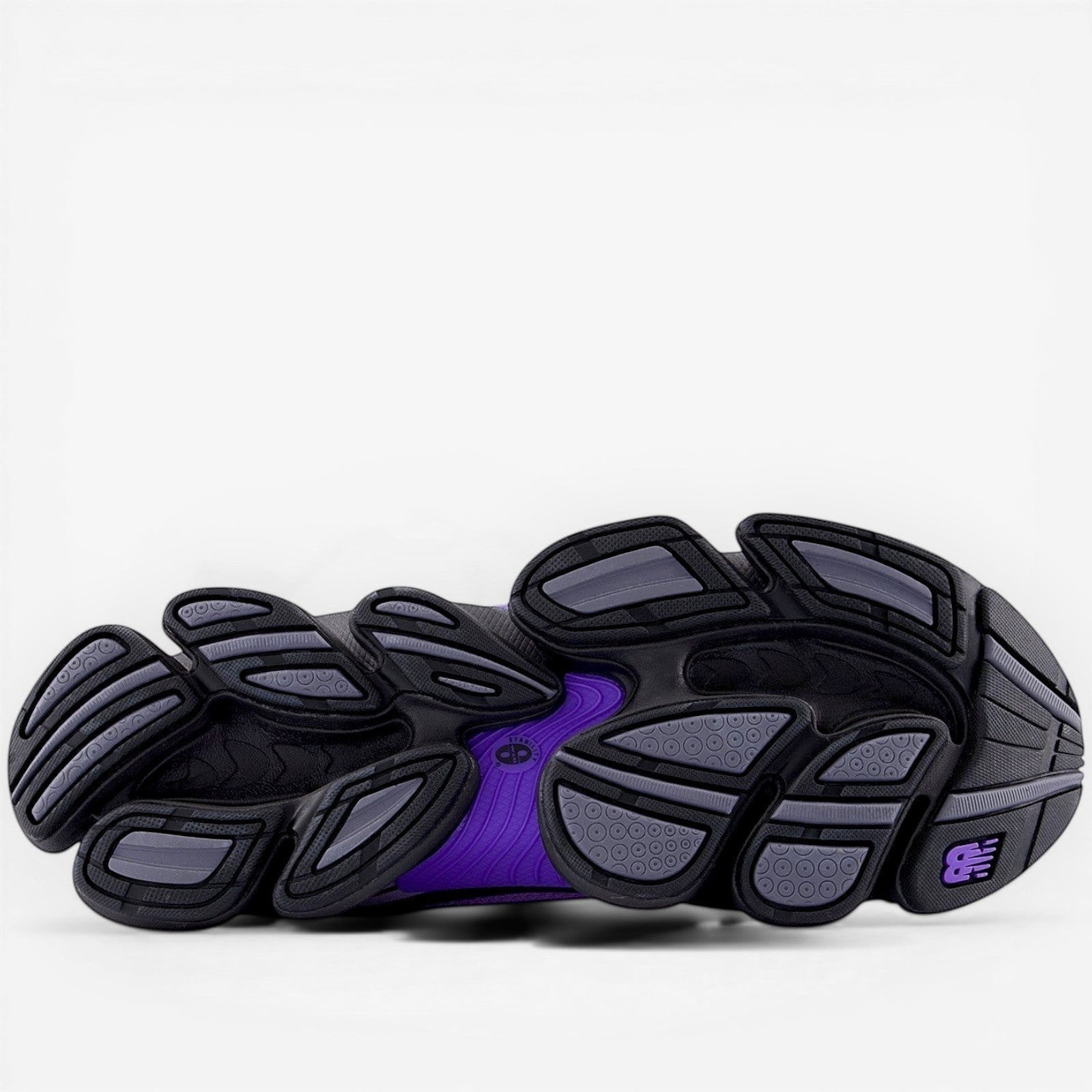 New Balance sneaker outsole in black, grey, and purple, athletic footwear sole detail