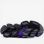 New Balance sneaker outsole in black, grey, and purple, athletic footwear sole detail