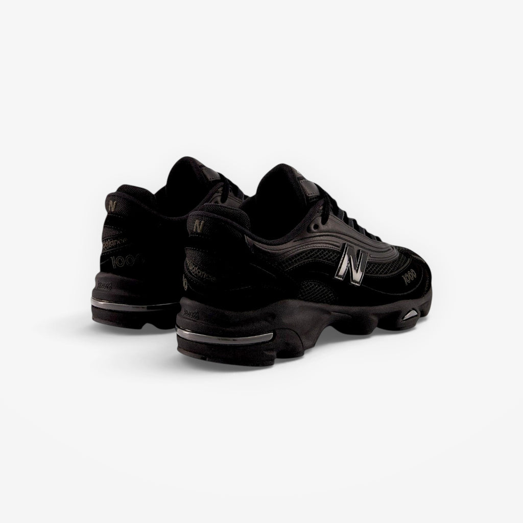 METRO New Balance M1000 black sneakers with mesh underlays, ABZORB cushioning, and sleek 1999-inspired design.