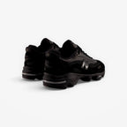 METRO New Balance M1000 black sneakers with mesh underlays, ABZORB cushioning, and sleek 1999-inspired design.