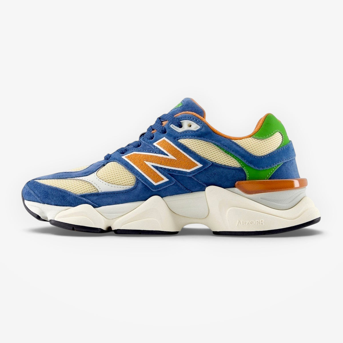 METRO New Balance U9060 Shoreline Blue sneakers featuring blue suede, cream mesh, and orange accents.