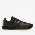 METRO Reebok Classic Leather black leather sneakers with grey accents and gum sole. Lace-up, low-top design.