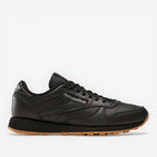 METRO Reebok Classic Leather black leather sneakers with grey accents and gum sole. Lace-up, low-top design.