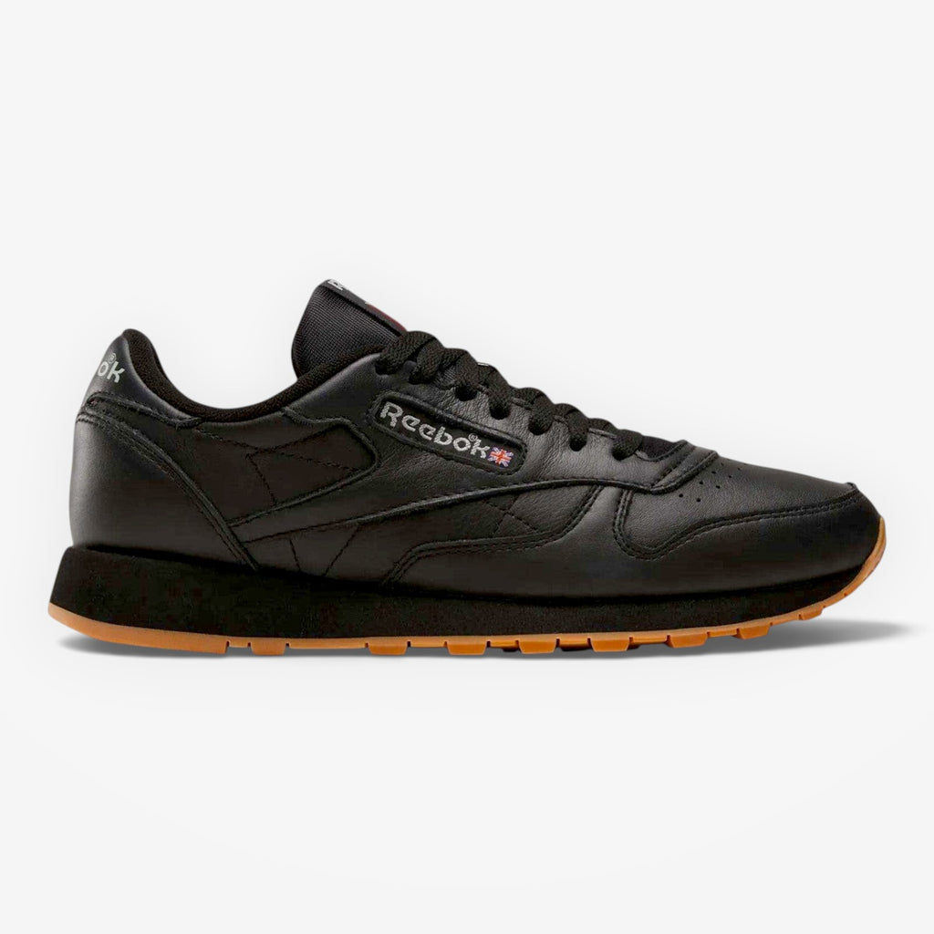 METRO Reebok Classic Leather black leather sneakers with grey accents and gum sole. Lace-up, low-top design.