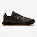 METRO Reebok Classic Leather black leather sneakers with grey accents and gum sole. Lace-up, low-top design.