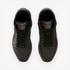 METRO Reebok Classic Leather black leather sneakers with grey accents and gum sole. Low-top lace-up style.