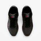 METRO Reebok Classic Leather black leather sneakers with grey accents and gum sole. Low-top lace-up style.