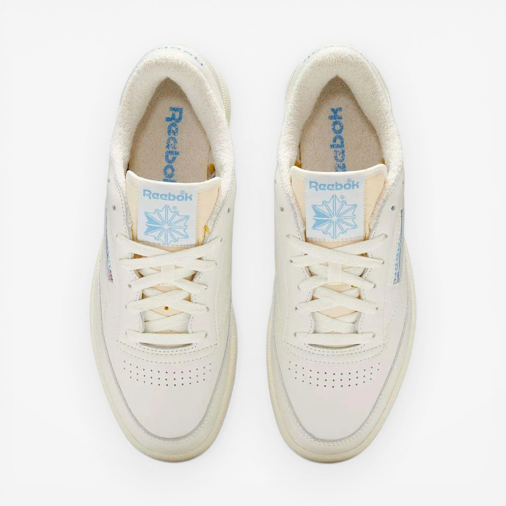 METRO Reebok Club C 85 Vintage low-top sneakers in chalk and essential blue leather with lace-up closure and rubber sole.