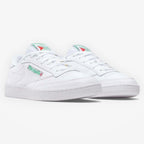METRO Reebok Club C 85 white leather low-top sneakers with green accents on the logo and heel tab. Lace-up closure.