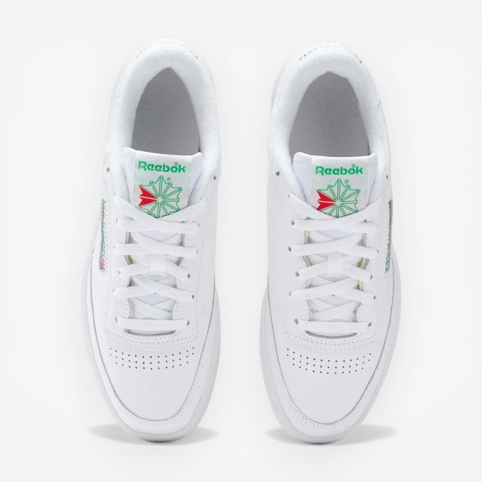 METRO Reebok Club C 85 white green leather low-top sneakers with lace-up closure and classic tennis shoe style.