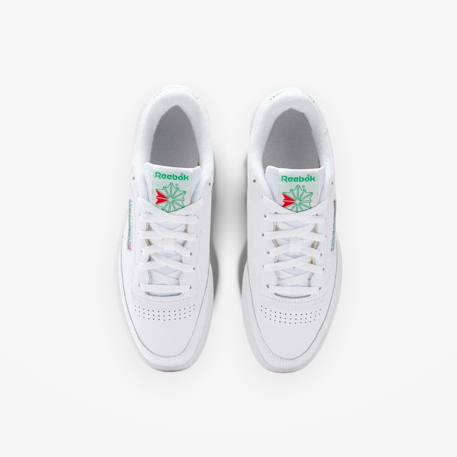 METRO Reebok Club C 85 white green leather low-top sneakers with lace-up closure and classic tennis shoe style.