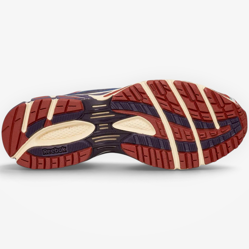 Metro Reebok Premier Road Ultra sneaker outsole in red, teal, and white with textured grip and Reebok branding.