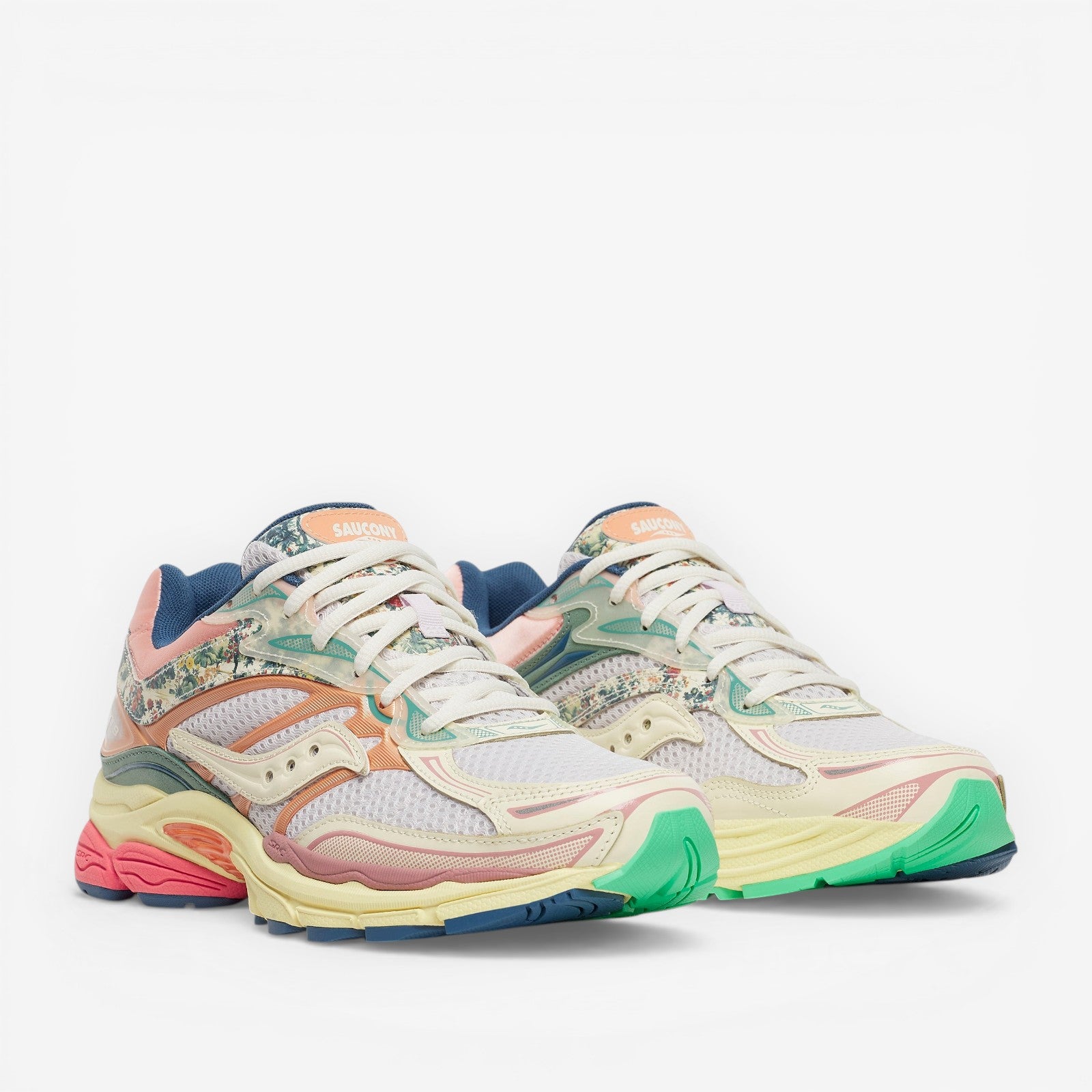 METRO Saucony ProGrid Omni 9 sneakers in beige, blue, pink, and green with floral print accents. Mesh and synthetic overlays.