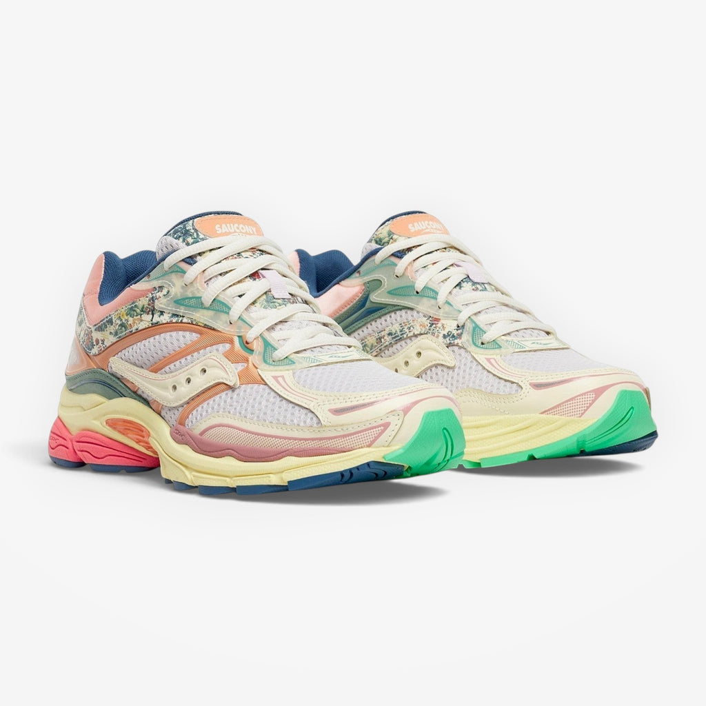 METRO Saucony ProGrid Omni 9 sneakers in beige, blue, pink, and green with floral print accents. Mesh and synthetic overlays.