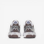 METRO ProGrid Omni 9 retro runner sneakers in white, brown, and silver mesh with synthetic overlays and ProGrid cushioning.